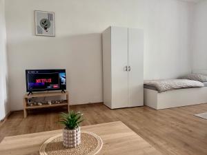 a living room with a tv and a table at StayU Apartment in Ústí nad Labem