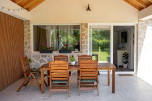 a patio with a wooden table and chairs at Casa Carlo in Sinj