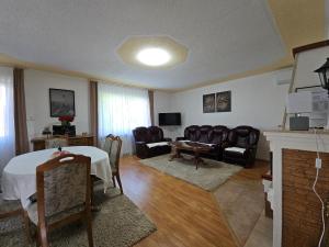 a living room with a table and chairs at Villa Aylin in Bihać