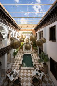 a room with a pool in the middle of a building at Riad Le Saadien ,Adult only in Marrakesh