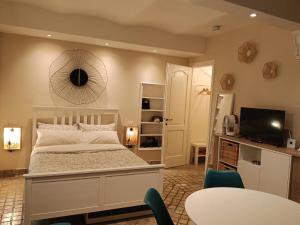 a bedroom with a white bed and a table and chairs at MancioBiba Home in Trevi