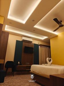 a hotel room with a bed and a ceiling at Hotel Mukti Residency in Mātigara +22 photos