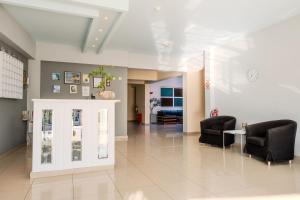 a waiting room with two chairs and a table at Atrium Hotel in Leptokarya