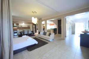 a bedroom with a bed and a couch and a kitchen at Luxury Heaven farm one in Kastoria