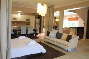 a living room with a couch and a dining room at Luxury Heaven farm one in Kastoria