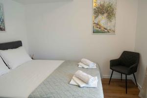 a bedroom with a bed with two towels on it at Casa Carlo in Sinj