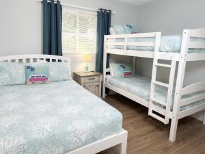 a bedroom with two bunk beds and a desk at Family Getaway - Boardwalk to the Beach, 3 pools, Tennis in Hilton Head Island