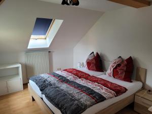 a bedroom with a bed with red pillows on it at Bella Vista in Burgstaedt