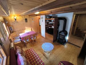 an overhead view of a living room with a table and a stove at Brunarica Marička in Idrijska Bela
