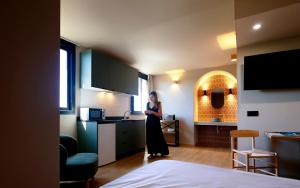 a woman standing in a kitchen in a room at Alcudia Boutique Apartments in Alcudia
