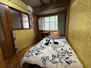 a bedroom with a bed with a dog laying on it at HANA88のa,b in Otsu