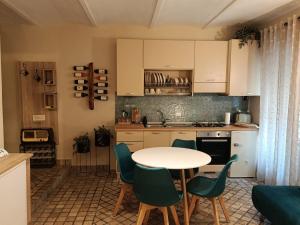 a kitchen with a table and chairs in a kitchen at MancioBiba Home in Trevi