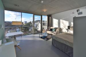 a bedroom with a bed and a large window at Loft Apartments in Schorndorf