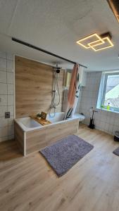 a bathroom with a tub and a sink in a room at Lahnblick teilw Sauna-Infrarot aktuell Straßenbaustelle in Lahnstein +69 photos