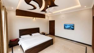 a bedroom with a bed and a chandelier at Canvas 430 in Islamabad +18 photos