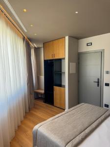 a bedroom with a bed and a closet and a door at The Q House in Foligno