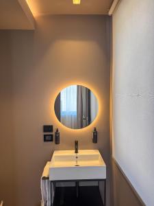 a bathroom with a sink and a mirror at The Q House in Foligno