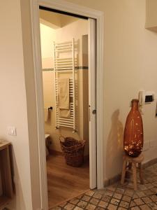 a glass door leading to a bathroom with a vase at MancioBiba Home in Trevi +41 photos