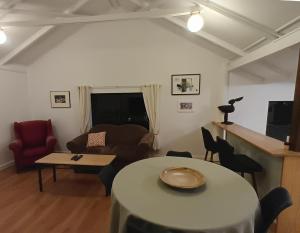 a living room with a table and a couch at Fairview Retreat in Clunes