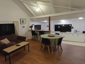 a living room with a table and a couch at Fairview Retreat in Clunes