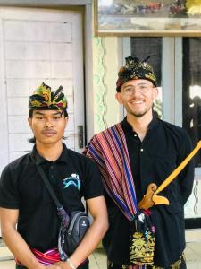 two men wearing hats standing next to each other at Adi Guest house in Blongas