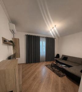 a living room with a couch and a window at Happy 2Rooms Apartament in Pipera