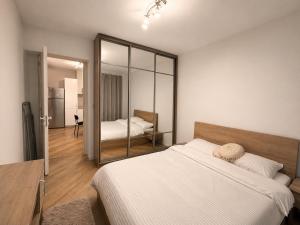 a bedroom with a bed and a mirror at Happy 2Rooms Apartament in Pipera