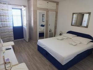 a bedroom with a large bed and a mirror at Borovik Guest House in Živogošće +26 photos