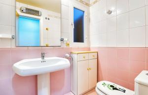 a pink bathroom with a sink and a toilet at Escondite Brisa Marina in Calpe +15 photos