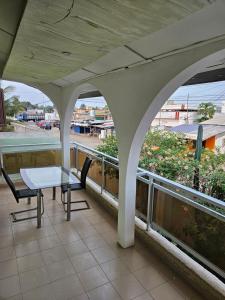 a table and chairs on a balcony with a view at Le Rêve d'Or in Lomé