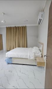 a bedroom with a bed and a window at Sahalnoot flats in Salalah