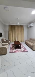 a living room with a couch and a coffee table at Sahalnoot flats in Salalah +2 photos