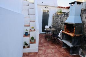 a room with a fireplace and a table with plants at Ribeira Mar Guesthouse in Viana do Castelo