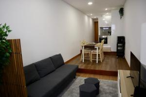 a living room with a couch and a table at Ribeira Mar Guesthouse in Viana do Castelo +3 photos