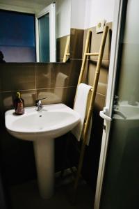 a bathroom with a white sink and a mirror at Ribeira Mar Guesthouse in Viana do Castelo