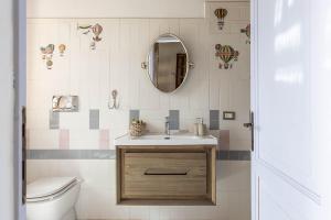 a bathroom with a sink and a toilet and a mirror at Borgo Tignano in Casole dʼElsa +32 photos