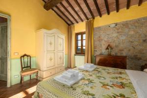 a bedroom with a bed with two towels on it at Borgo Tignano in Casole dʼElsa