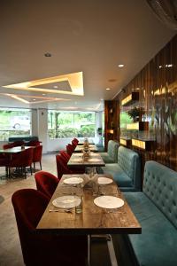 a restaurant with long tables and chairs and a pool at The Hoften Blue Magnets, Dalhousie in Dalhousie