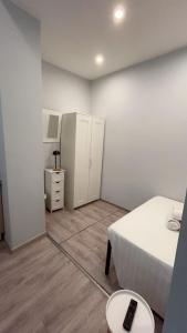a bedroom with a bed and a table and a cabinet at European District Hostel in Brussels