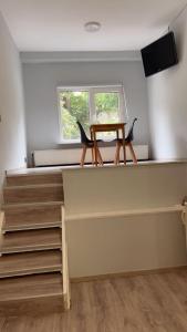 a table and two chairs sitting in a room at European District Hostel in Brussels