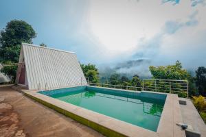 a swimming pool with a view of the mountains at The Breeze Cottage in Kalasa +42 photos