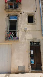 a building with a door and a window and a balcony at Cool in Cévennes in Le Vigan +1 photo