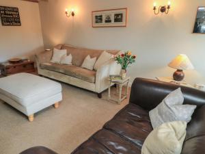 a living room with a couch and a coffee table at 2 The Gardens in Lechlade