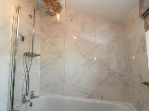 a bathroom with a shower and a white tub at 2 The Gardens in Lechlade +16 photos