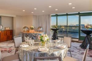 a dining room with tables and chairs and a large window at Chicago Marriott Suites Deerfield in Deerfield
