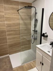 a shower with a glass door in a bathroom at Les Robinsons in Sillans-la Cascade