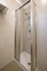 a shower with a glass door in a bathroom at Residence Columbia in Bibione +36 photos