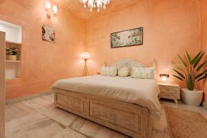 a bedroom with a large bed and a chandelier at Misty BNB And Homestay in Jaipur