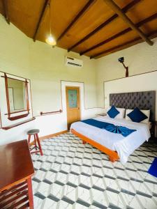 a bedroom with a bed and a desk in it at Royal Mount Ella in Ella