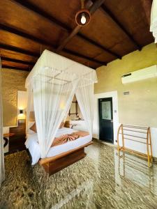 a bedroom with a bed with mosquito net at Royal Mount Ella in Ella